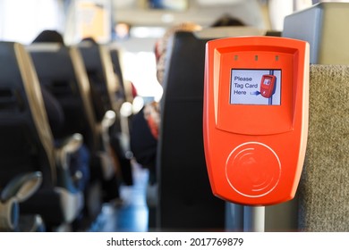 Orange ticket validation machine on a modern public transport bus - Shutterstock ID 2017769879