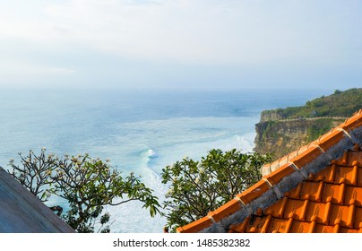 Orange tiled roof on a background of ocean coast near the temple of Uluwatu, Bali, Indonesia