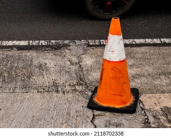 Orange Traffic Cone On The Side Of The Road
