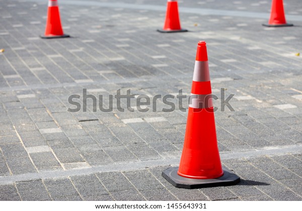 Orange traffic cone on the\
street 