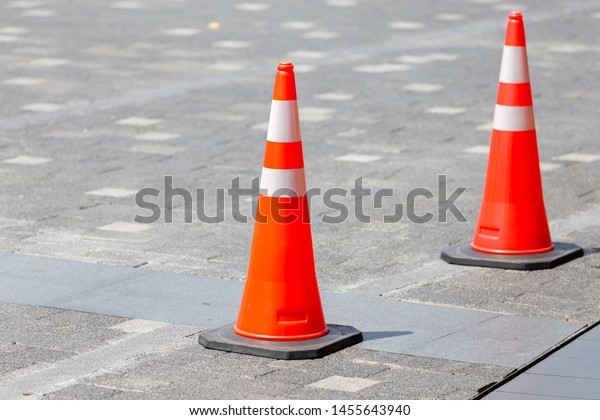 Orange traffic cone on the\
street 