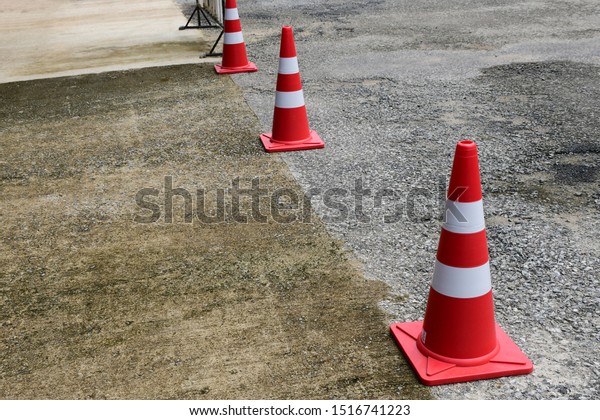 Orange traffic cone are placed\
to protect the dangers of driving or land traffic to ensure\
safety.