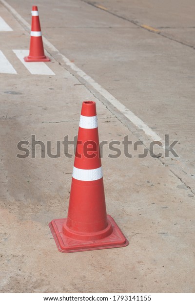 orange traffic cone in the\
road