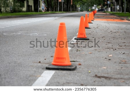 Orange traffic cones on the road. Urban environment.