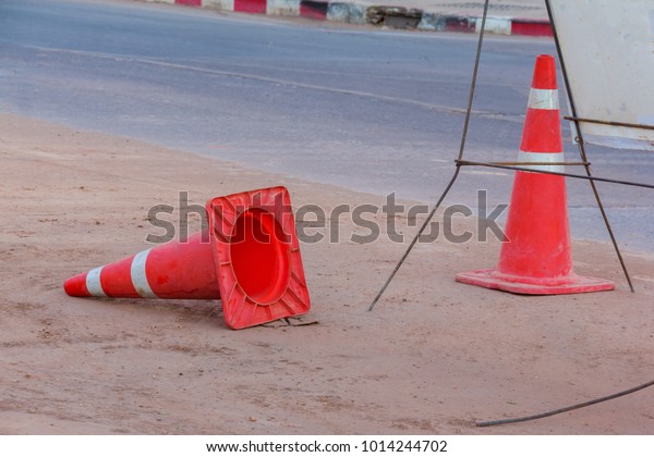orange traffic cones on\
road in city