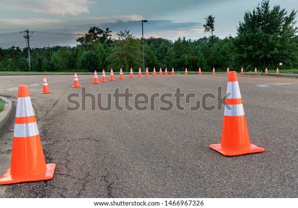 Orange traffic cones on roadway to help with the\
flow of vehicles in\
traffic