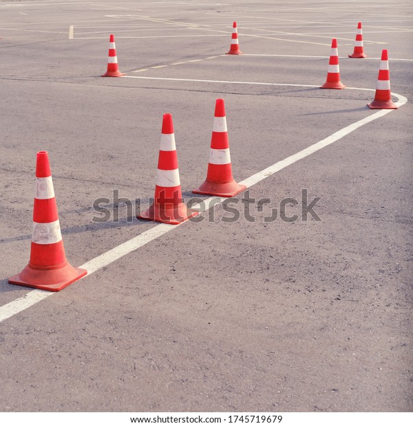 Orange traffic cones on a site in a driving\
school and parallel\
parking