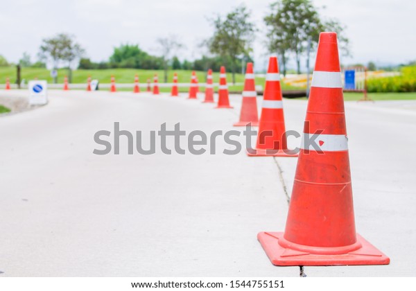 The orange traffic cones were installed in the\
middle of the road to alert motorists to slow down when they saw\
the orange cones.\
The idea of warning to slow down by using the\
orange traffic cones.