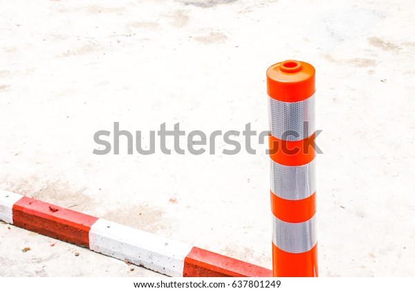 Orange traffic reflective bollards,Plastic pole\
traffic sign in parking car\
area