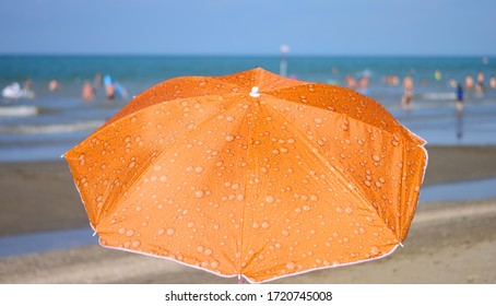 An Orange Umbrella On The Beach