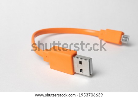  Orange USB micro-usb cabel isolated on grey background