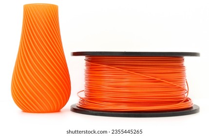Orange vase and filament for 3d printing, isolated on white background, 3D Printer Filament, TPU Filament, horizontal view, macro