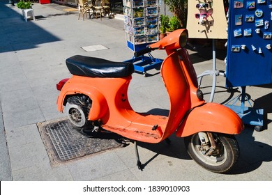 Orange Vesper Scooter Parked On Italian Sidewalk , Rome, Italy, Shoot Date: 07/14/2013