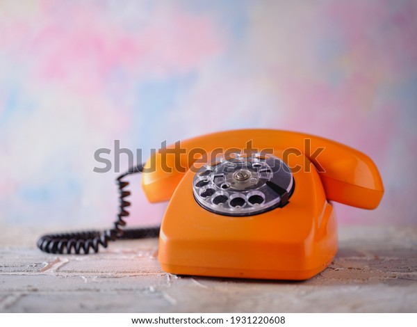 Orange vintage phone on the\
table