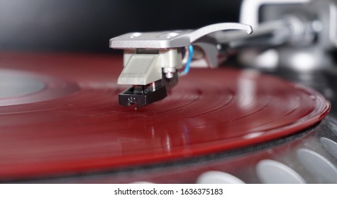 Orange vinyl record on turntable - Shutterstock ID 1636375183