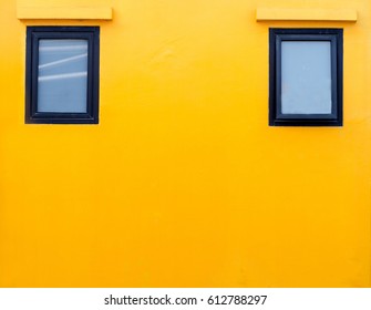 Orange Wall With Two Windows Outside The House