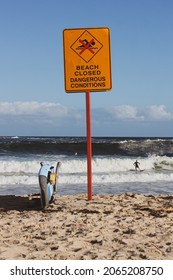 An Orange Warning Sign Of Closed Beach Because Of Dangerous Conditions