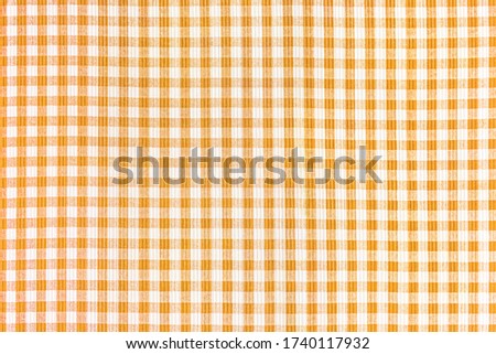 Orange and white abstract checkered pattern background, picnic tablecloth, square fabric texture