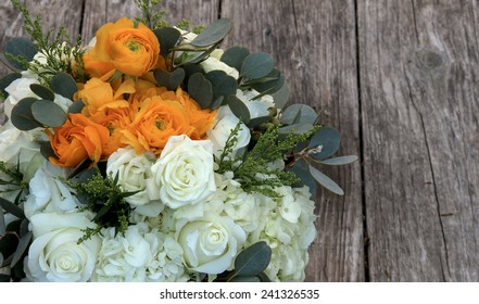 Orange And White Bouquet Of Flowers On A Farm Table Of Distressed Wood In Farm Country Before A Summer Wedding, July 4, 2014