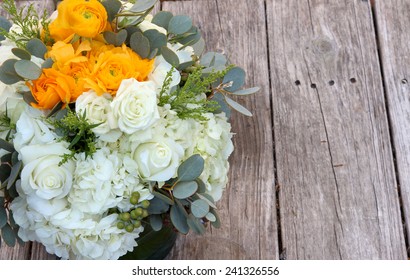 Orange And White Bouquet Of Flowers On A Farm Table Of Distressed Wood In Farm Country Before A Summer Wedding, July 4, 2014