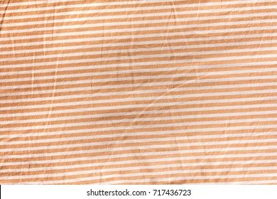 The orange and white color pattern of bed sheet cloth, background texture