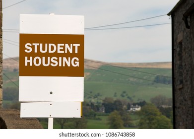 Orange And White Student Housing Sign Against Idyllic Countryside Backdrop