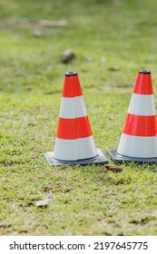 Orange And White Traffic Light Cone On A Lawn In Rio De Janeiro.