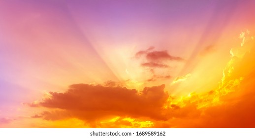 orange yellow aglow sunset light on pink sky with sun rays light - Shutterstock ID 1689589162