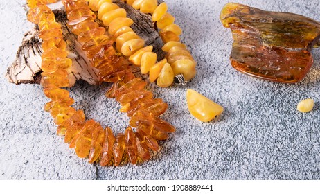 Orange And Yellow Baltic Amber Necklaces On A Birch Bark.