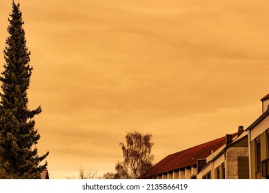 Orange Yellow Clouds Over The Roofs Of Augsburg City During Sahara Dust Storm