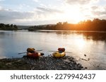 Orange and yellow packrafts rubber boats with padles on a sunrise Dnister river. Packrafting background. Active lifestile concept