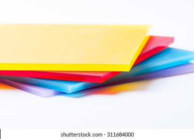 Orange yellow red blue purple plexi glass sheets on the white background