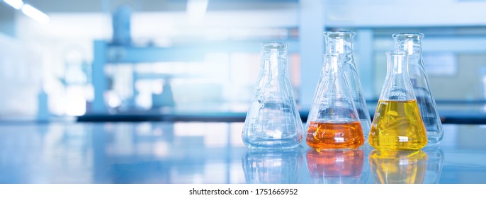 Orange Yellow Solution In Science Glass Flask Win Blue Chemistry Laboratory Banner Background