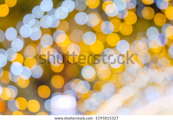 Orange, yellow\
and white bokeh light at Festival. Abstract or blurred of light\
glitter. Glow texture\
background.
