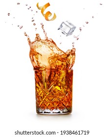 Orange zest and ice cube falling into a splashing drink. Godfather or old fashioned cocktail isolated on white background. - Shutterstock ID 1938461719