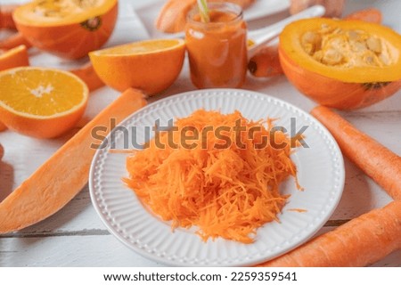 Oranged colored vegetables and fruit on white background. Closeup and front view