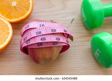 Oranges Close Up With Measuring Tape And Dumb Bells.Diet And Loss Weight Concept Related 