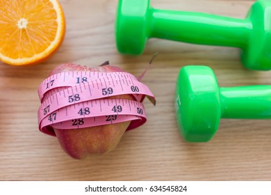 Oranges Close Up With Measuring Tape And Dumb Bells.Diet And Loss Weight Concept Related 