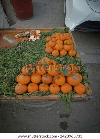 Oranges in grass fruits colors in handcart portrait image of saturated colors and blacks looks beautiful wallpaper in punjab city lahore 