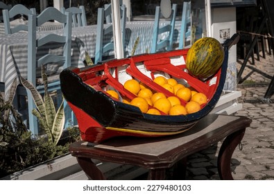Oranges and melon on display in a model Portuguese fishing boat - Shutterstock ID 2279480103