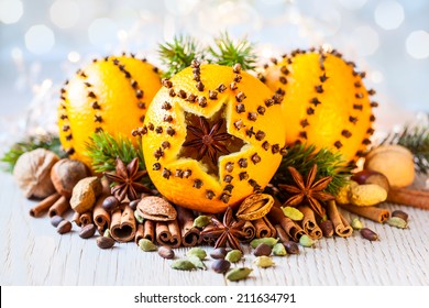 Oranges pierced with cloves,Christmas spices and nuts - Powered by Shutterstock