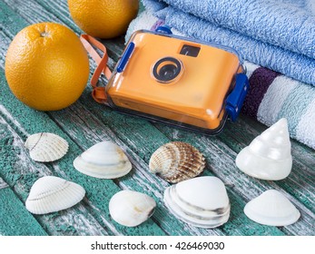 Oranges and waterproof camera on blue towel background. Summer holiday concept - Shutterstock ID 426469030
