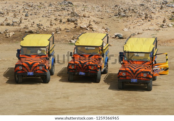 Oranjestad, Aruba - November 17, 2018 - The unique\
orange color of transportation on the extreme Jeep Safari tour\
around the island