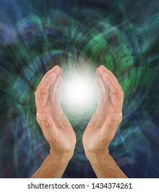 Orb Light Paranormal Phenomenon  - Hands Cupped Around A Bright White Orb Light Against A Green Rotating Energy Field Background With Copy Space
