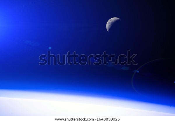 Orbital dawn\
from the space station. Moon. Blue glow. Background, texture.\
Elements of this image furnished by\
NASA.