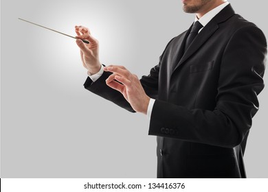 Orchestra Conductor Directing With His Baton