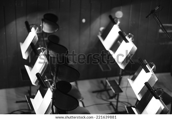 Orchestra pit,\
chairs and music stands;\
monochrome