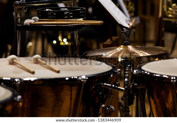 Orchestral\
percussion instruments in dark colors\
close-up