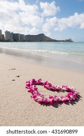 orchid flower garland necklace in love heart shape on white sand beach, romantic couple honeymoon trip at Hawaii 
