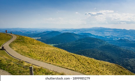 Orcines, France - September 16th, 2019: path and view on the Chaine des Puys volcanoes range from the top of the Puy de Dome, the most famous volcano this range, in Auvergne, France